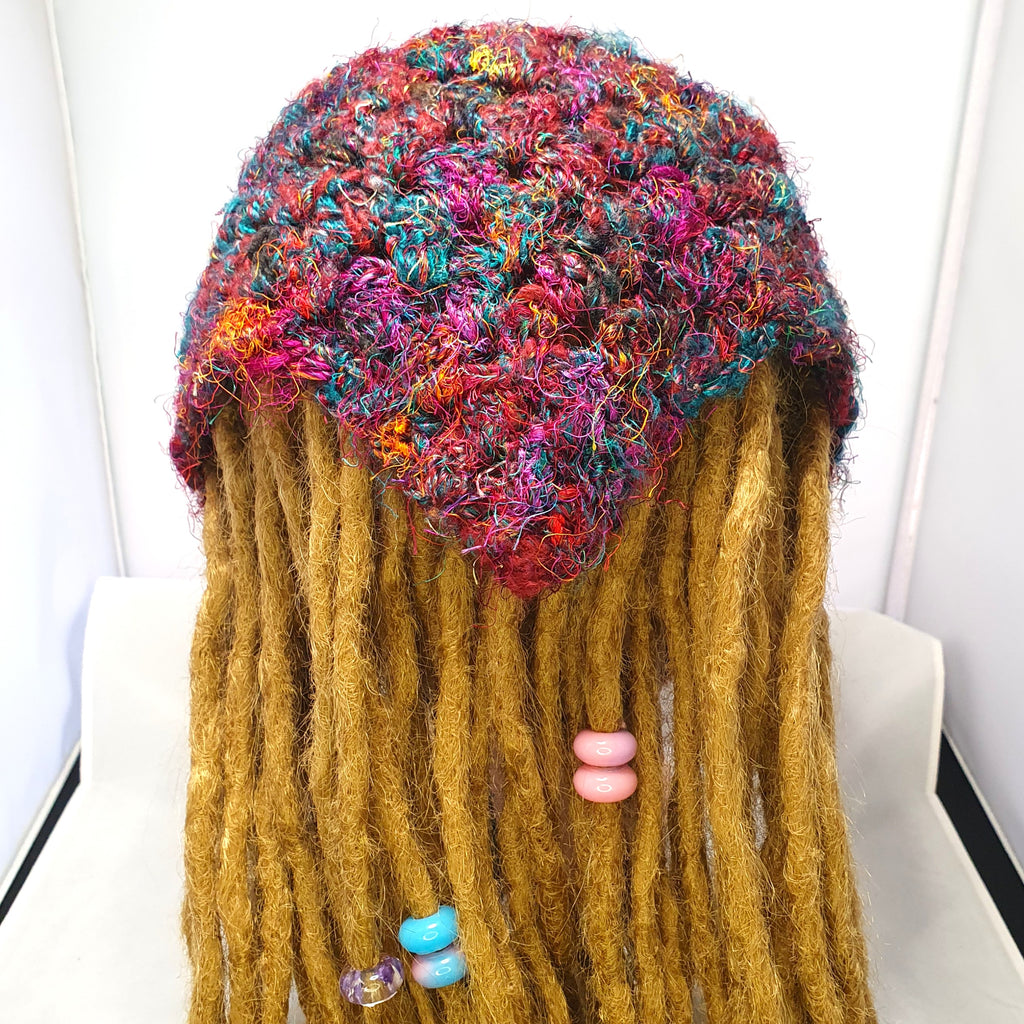 Multicolour sari silk crochet loc bandana worn over golden dreadlocks, shown from behind