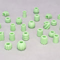 Assorted glow in the dark 3D printed dreadlock beads in mint green, variety of shapes including ribbed, spiral, star and sphere